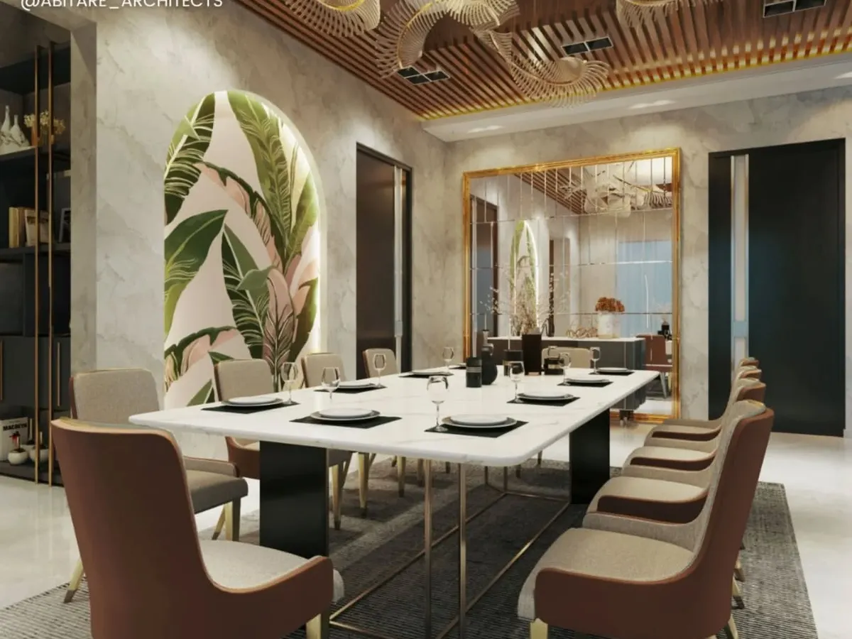 I designed this dining room to be a warm and inviting space for gatherings. The design features a statement marble tabletop, sculptural overhead lighting, and a slatted wood ceiling, all balanced by a botanical accent wall that adds a touch of nature.