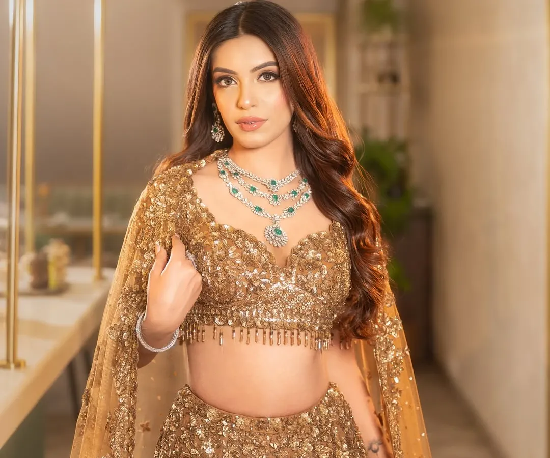 For the bride who wants to shine at her reception or cocktail party. I created these voluminous, soft glam waves to complement this stunning golden lehenga, ensuring she glittered with every step.