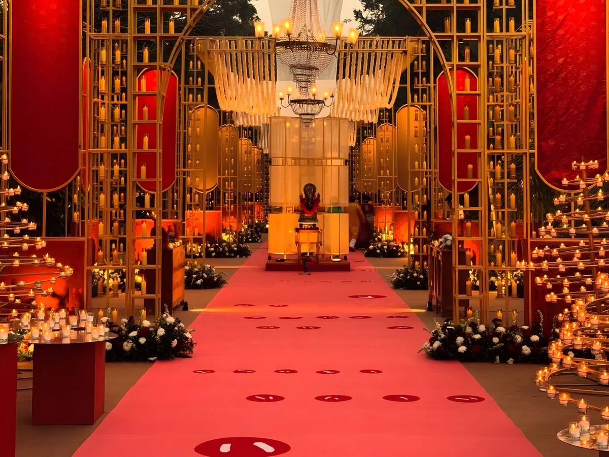 We designed this grand entrance for a sacred Ganesh Puja, creating a pathway of light and devotion. Hundreds of candles within golden arches and a vibrant red carpet guide guests toward the ceremony, creating a powerful sense of arrival and reverence.