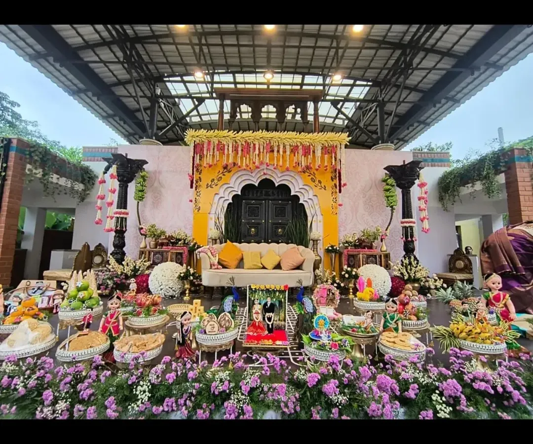 We specialize in creating grand and authentic settings for traditional ceremonies. This elaborate Seemantha (baby shower) setup combines a beautiful floral stage with a full display of traditionally decorated plates, ensuring every detail is perfect.