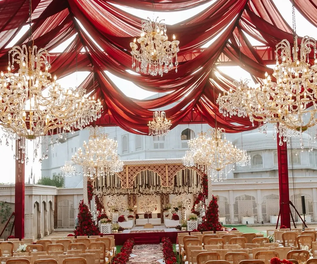 For Naomi and Rakshit's 'Laal Ishq' wedding, we created a royal atmosphere at Fairmont Jaipur. This grand setup features dramatic red draping and magnificent crystal chandeliers, embodying a timeless and luxurious Indian wedding aesthetic.