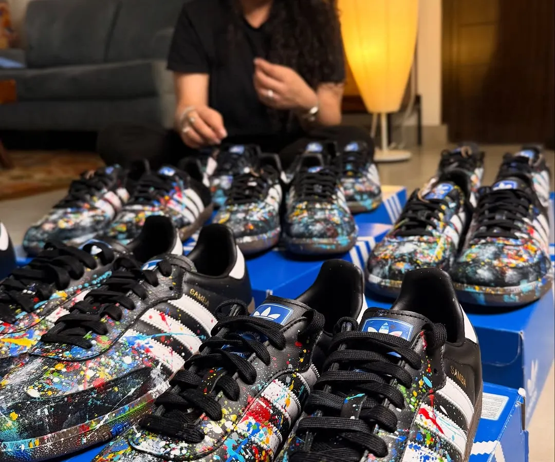 Here I am with a large commission of nine pairs of Adidas Sambas. Each shoe was hand-painted with a unique splatter design for a private client, showing how I can handle bulk orders for events or teams while ensuring every single piece is a work of art.