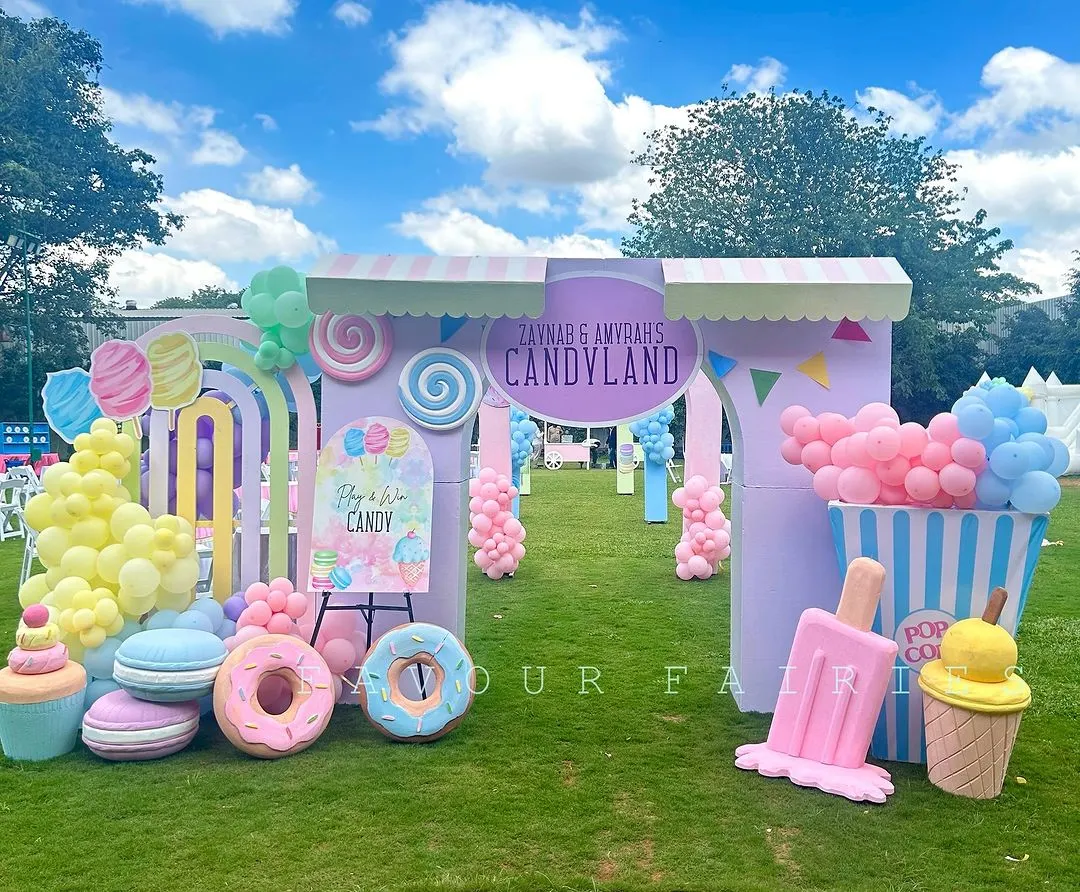 Welcome to the sweetest party in town. We designed this sprawling outdoor Candyland theme with a grand entrance, giant pastel lollipops, donuts, and ice cream props, creating a whimsical wonderland for guests to explore.
