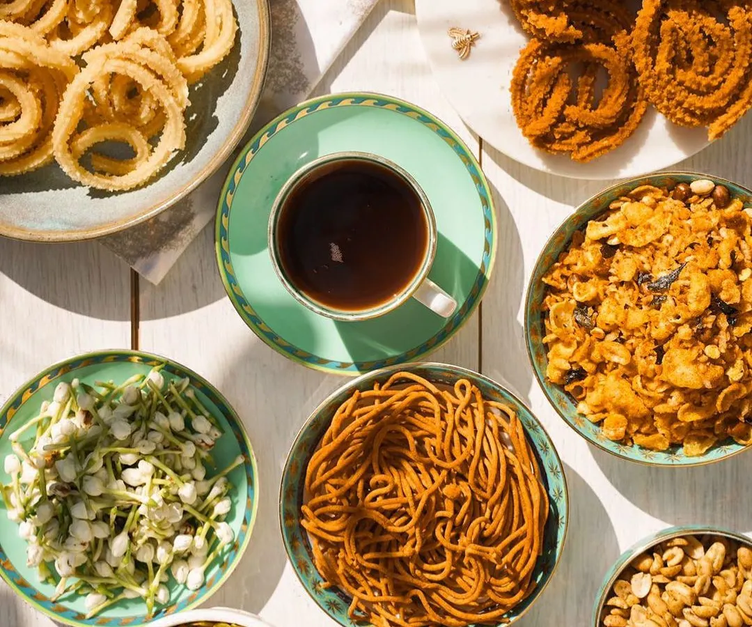 A table full of my homemade snacks is a table full of joy. Here you can see a spread of my offerings, from savory Murukku and Ompudi to sweet Peanut Chikki, all ready for your coffee-time munchies.