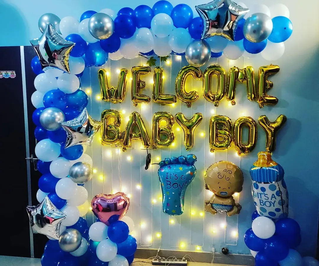 A classic 'Welcome Baby Boy' setup. This decoration features a balloon arch in blue, white, and silver, with large foil letters. I also added fun baby-themed foils like a baby foot, a milk bottle, and a baby character to make it extra special.