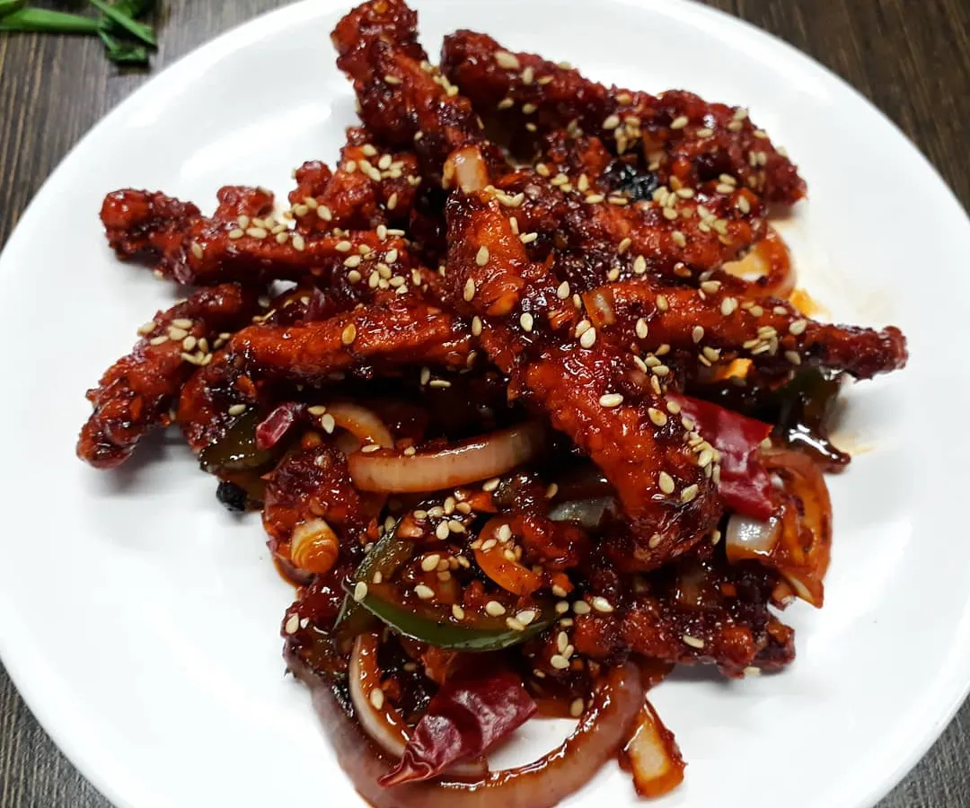 A crowd favourite, our Honey Chilli Crispy Chicken. We fry chicken strips until they are perfectly crunchy and then toss them in a sweet and spicy honey chilli sauce with onions and peppers.