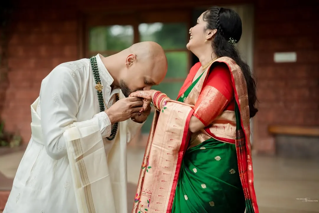 A moment of pure adoration and tradition. We focus on capturing gestures like these that speak volumes, blending chivalry with the rich textures of heritage attire.