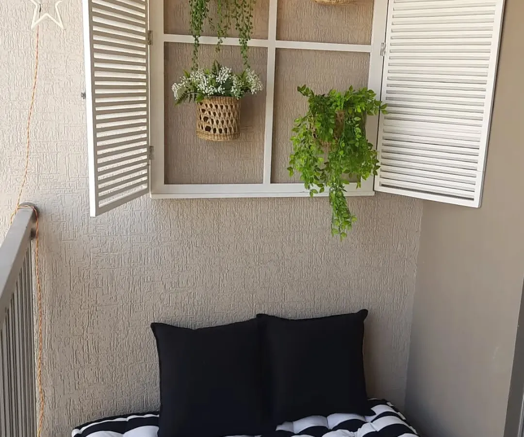 A cosy reading nook is a dream for so many. I created this peaceful corner using a low wooden pallet bench with a comfy striped mattress and a decorative French window to add a touch of architectural charm to a plain wall.