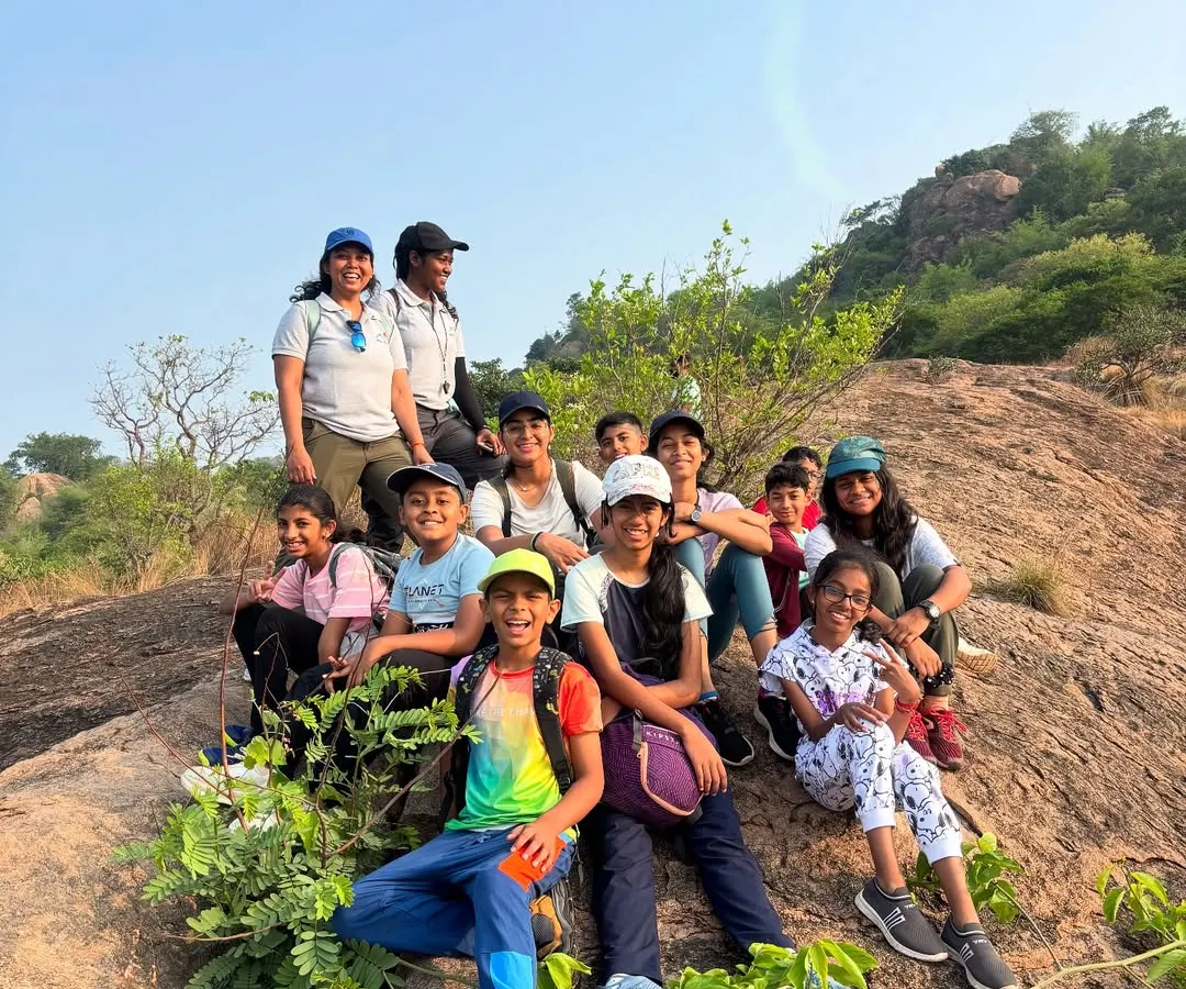 A happy group of our Young Adventurers and their instructors posing for a photo on the rocks during a hike. We focus on creating a fun, safe environment where kids can build confidence and make new friends.