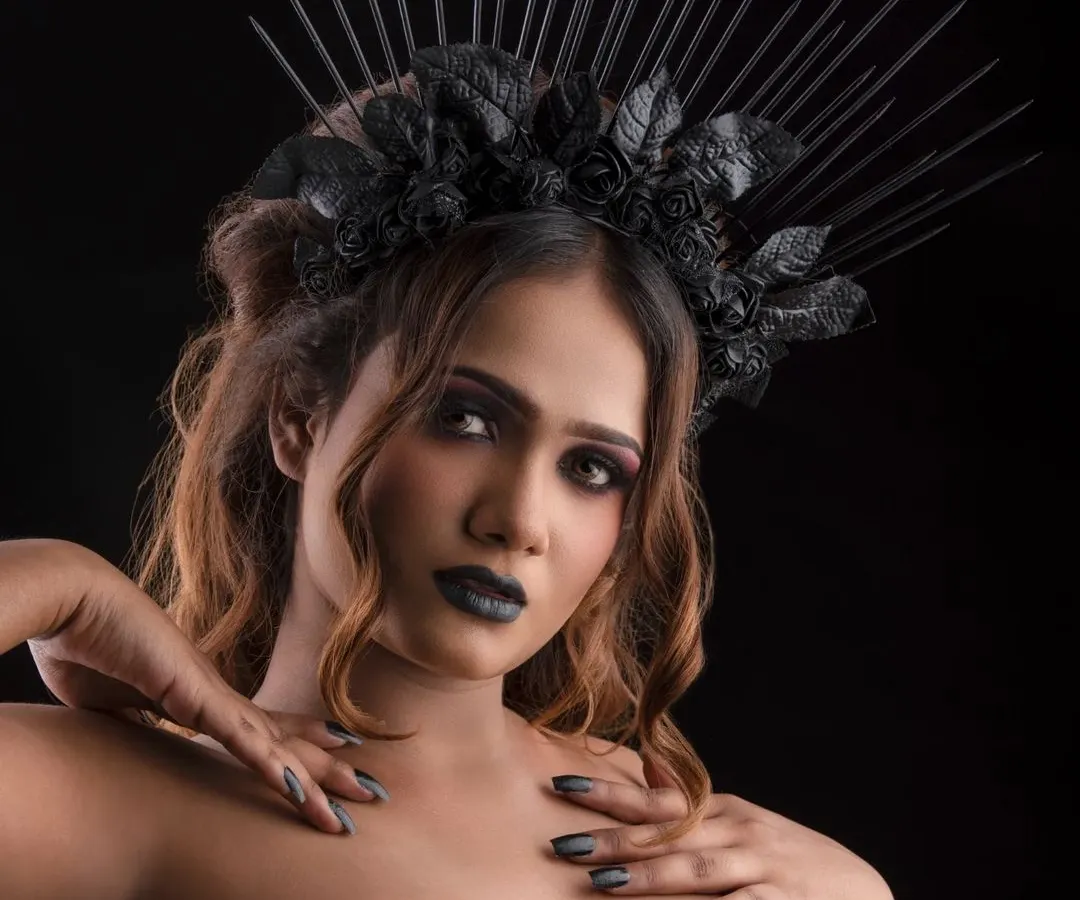 Creating a dark fantasy character with a dramatic black crown and intense makeup. The look features a deep smokey eye and bold black lipstick, perfect for a conceptual photoshoot or character transformation.