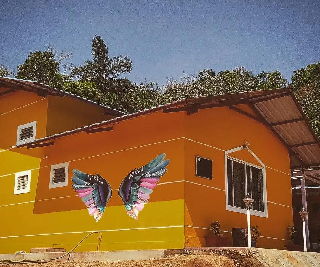 We gave this beautiful homestay in Sakleshpur a signature photo spot with these colorful wings. The art pops against the building's bright exterior and the natural scenery, making it an irresistible spot for guest photos.
