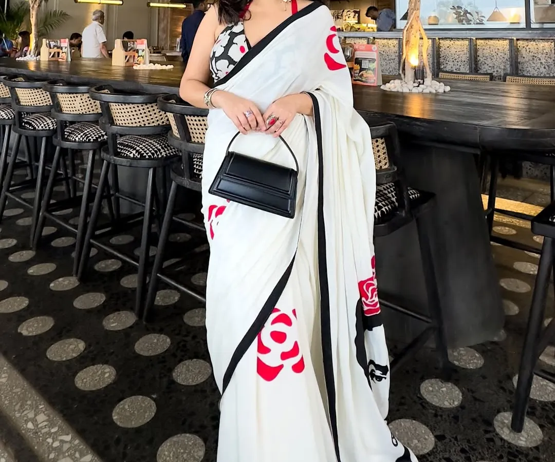 A modern saree look perfect for a special date night or a chic lunch. I believe in creating outfits that are memorable, combining unique pieces like this hand-painted saree with a contemporary halter-neck blouse and a structured bag for that clean, crisp, and confident vibe.