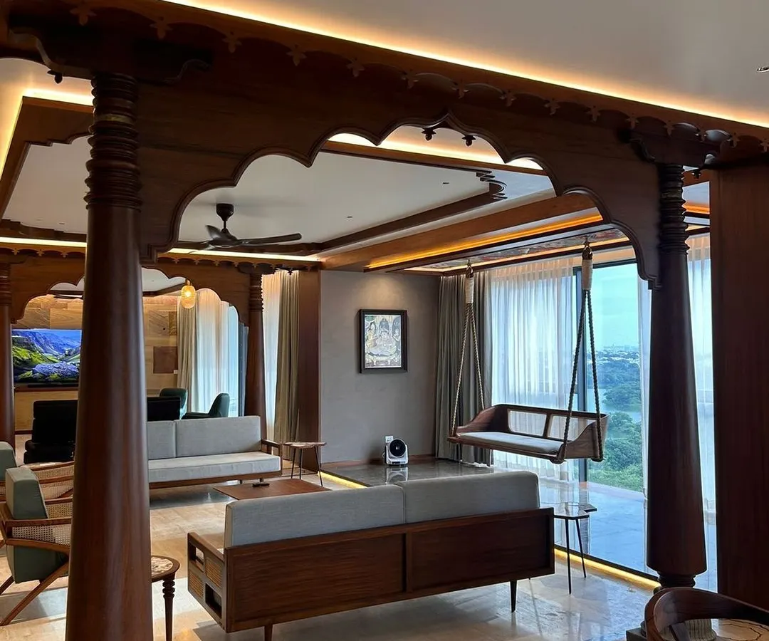 In this Bengaluru apartment, we integrated traditional Indian architectural elements within a contemporary living space. The intricately carved wooden pillars and oonjal (swing) create a focal point, celebrating heritage while maintaining a modern, open-concept feel.