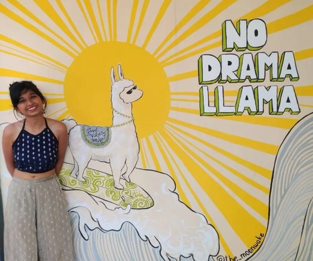 Here I am with one of my favorite quirky murals, the 'No Drama Llama', at a hostel in Goa. This piece was designed to be a fun, memorable photo opportunity for guests, and I was so happy to see it still bringing smiles six years after I first painted it.