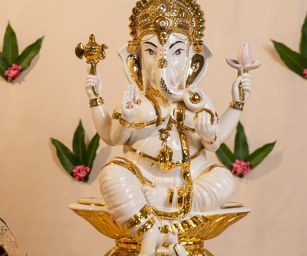 This is one of my favorite representations of Lord Ganesha, crafted in pristine white porcelain with delicate 24-karat gold detailing. He sits on a lotus base, bringing a sense of serene divinity and opulence to any sacred space in your home.
