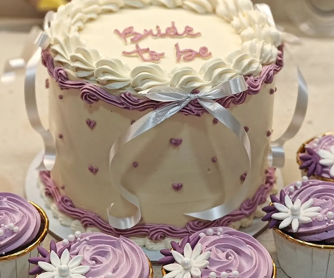 I'm obsessed with vintage cakes, and this "Bride to be" design is a perfect example. I used intricate piping techniques and delicate ribbons to create this elegant look for a special bridal shower. The flavor inside is my popular white chocolate and mixed berries.