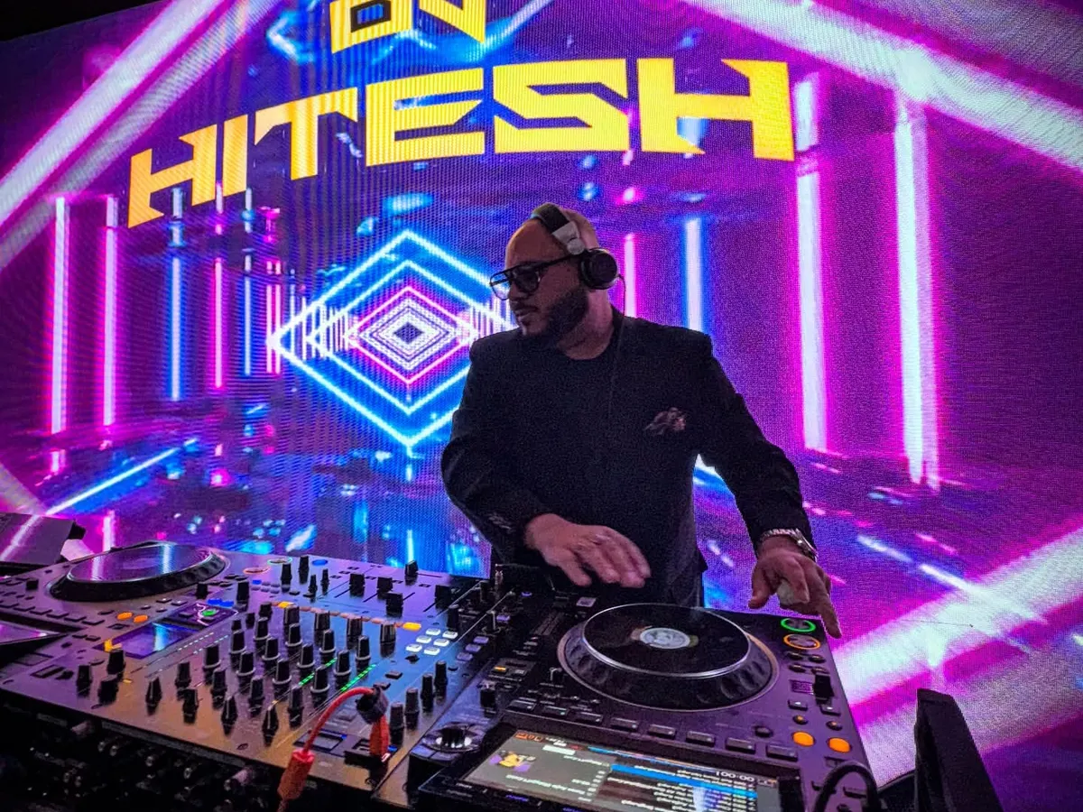 In the zone, surrounded by lights, with a packed dance floor ahead. This is my happy place, where I turn your wedding playlist into an unforgettable live experience.