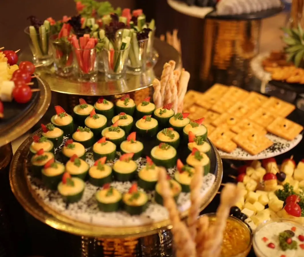 It's all about the details. This is a spread of my gourmet canapés, including cucumber cups with hummus and vegetable crudités in shot glasses. Each bite is designed to be a burst of flavour and a feast for the eyes.