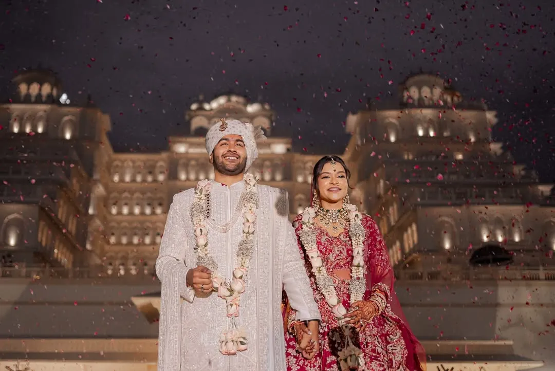 As confetti rains down against the backdrop of an illuminated palace, the couple shares their first moments as husband and wife. This is the kind of fairytale ending that marks a beautiful beginning, a memory of pure joy from a destination wedding in Jaipur.