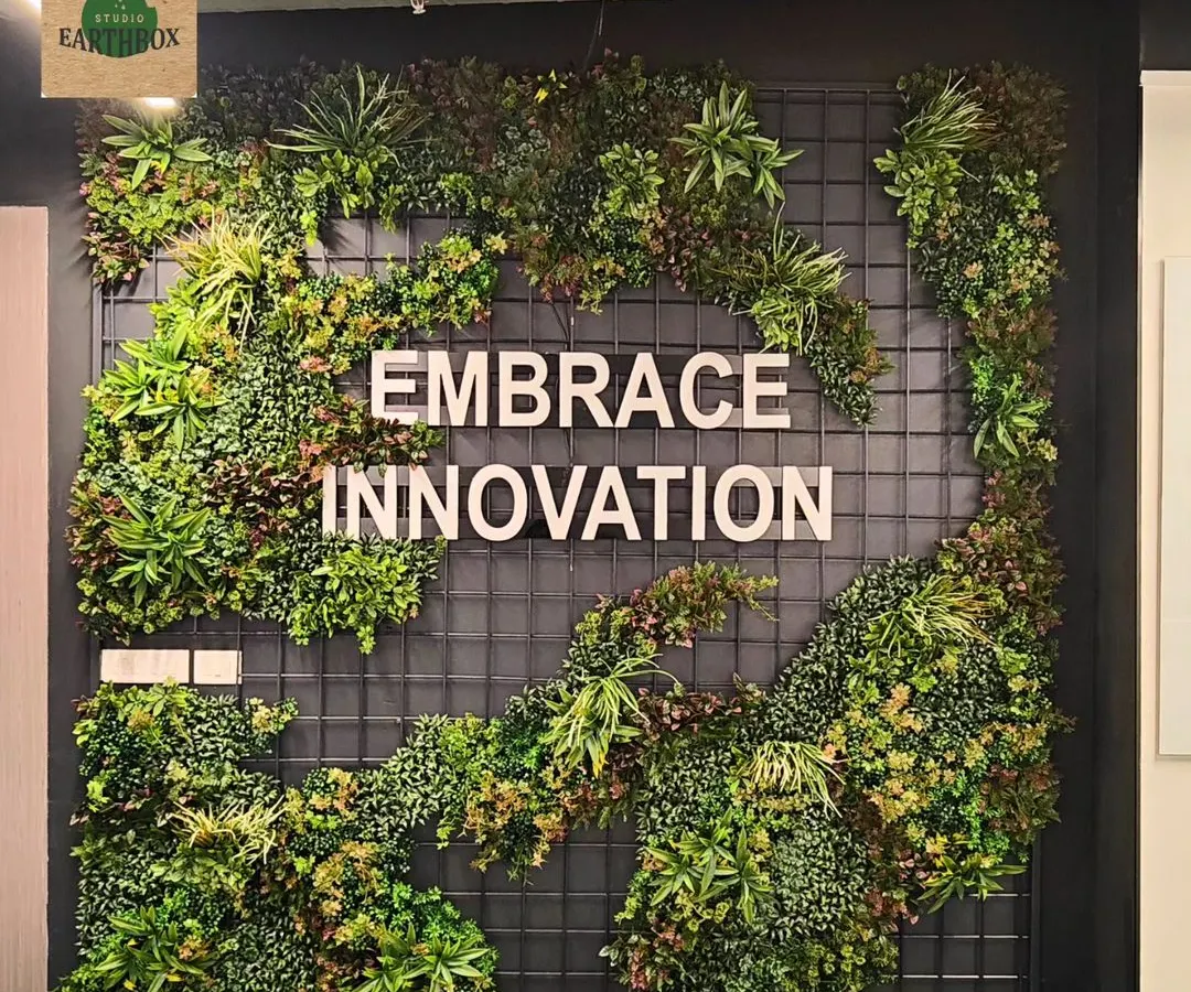 For this corporate office, we designed and installed a custom artificial green wall that frames their company motto. This zero-maintenance installation adds a powerful visual impact and a dose of nature to the modern workspace, making it a memorable feature for employees and visitors.