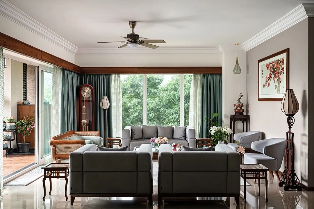 This living room is filled with the client's treasured antique furniture and art from their travels. We created a design that honors these pieces, blending traditional Indian elements with comfortable, contemporary living.