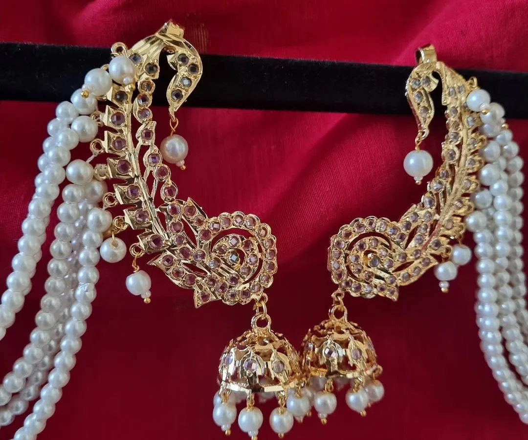 A close look at our gold-plated Hyderabadi Kimaya Earcuffs. Notice the intricate Jadau work and the cascade of pearls. This is a statement piece that blends royal heritage with modern craftsmanship, perfect for a bride or a wedding guest.
