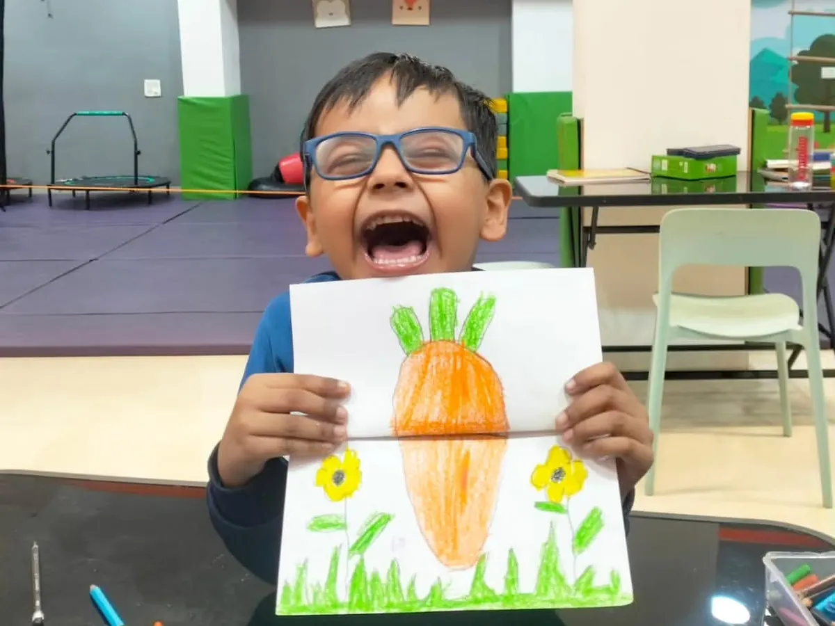 The pure joy of creation. This little artist is so proud of his surprise carrot and bunny drawing, a perfect example of the fun and imaginative art projects we do in our creative sessions.