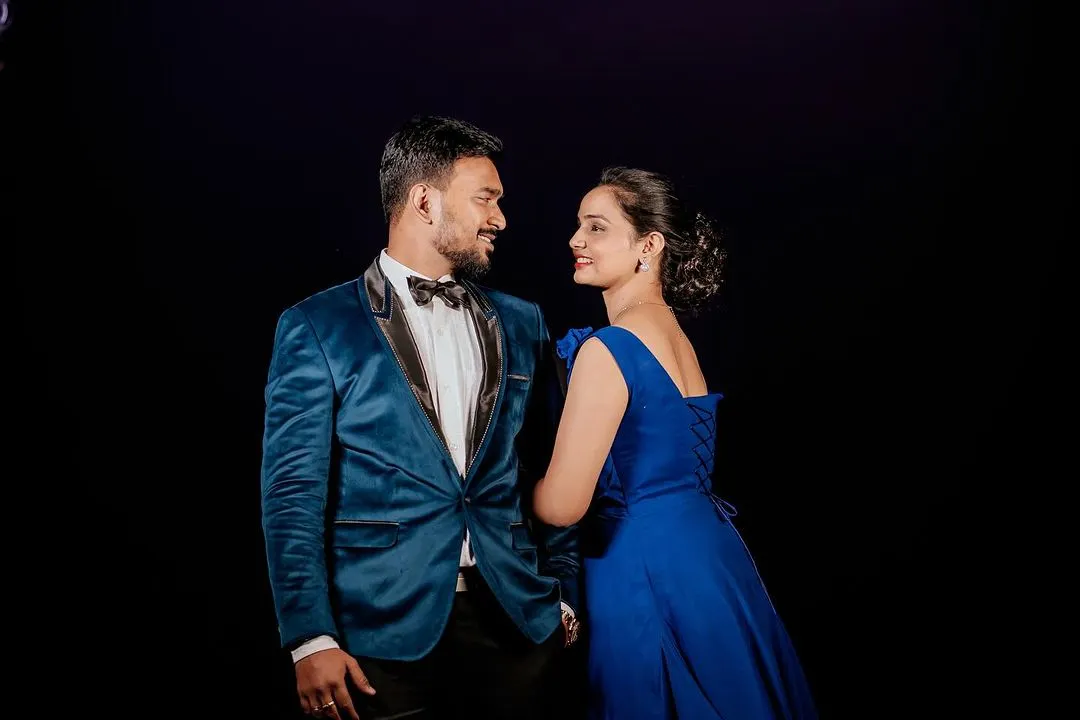 Capture your connection with an elegant couple's photoshoot. My studio's dramatic black backdrop makes colors pop and creates a timeless, intimate portrait perfect for pre-wedding memories.
