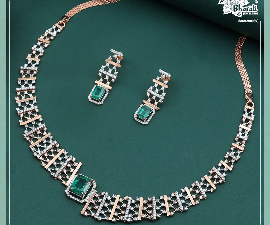 Our Emerald Zarnaya set embodies modern royalty. This 18ct rose gold necklace and earring suite features a geometric lattice of brilliant diamonds, punctuated by the deep, regal green of emeralds for a truly contemporary statement.