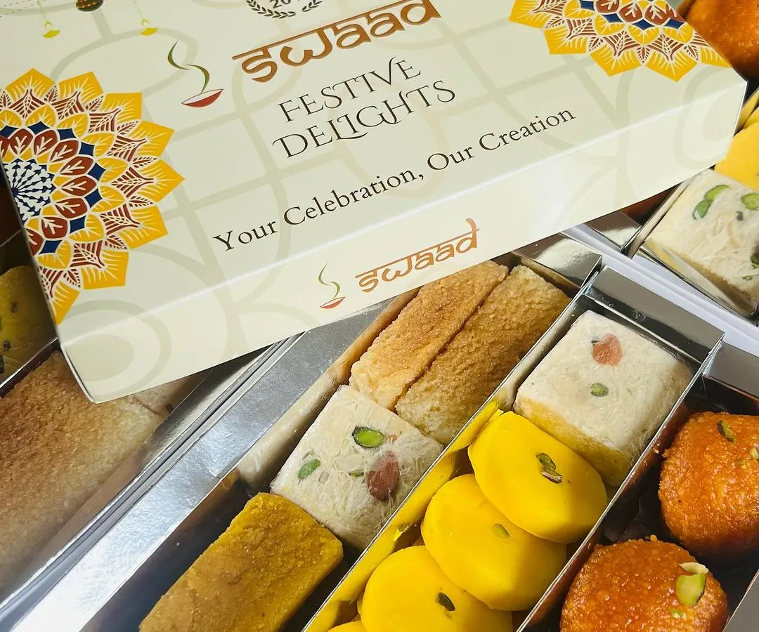 Here is our 'Festive Delights' assorted mithai box, opened to show the variety inside. We include a mix of our best sellers like Motichoor Ladoo, Peda, and Badam Pista Barfi, ensuring there's a favourite for everyone in your team or family.