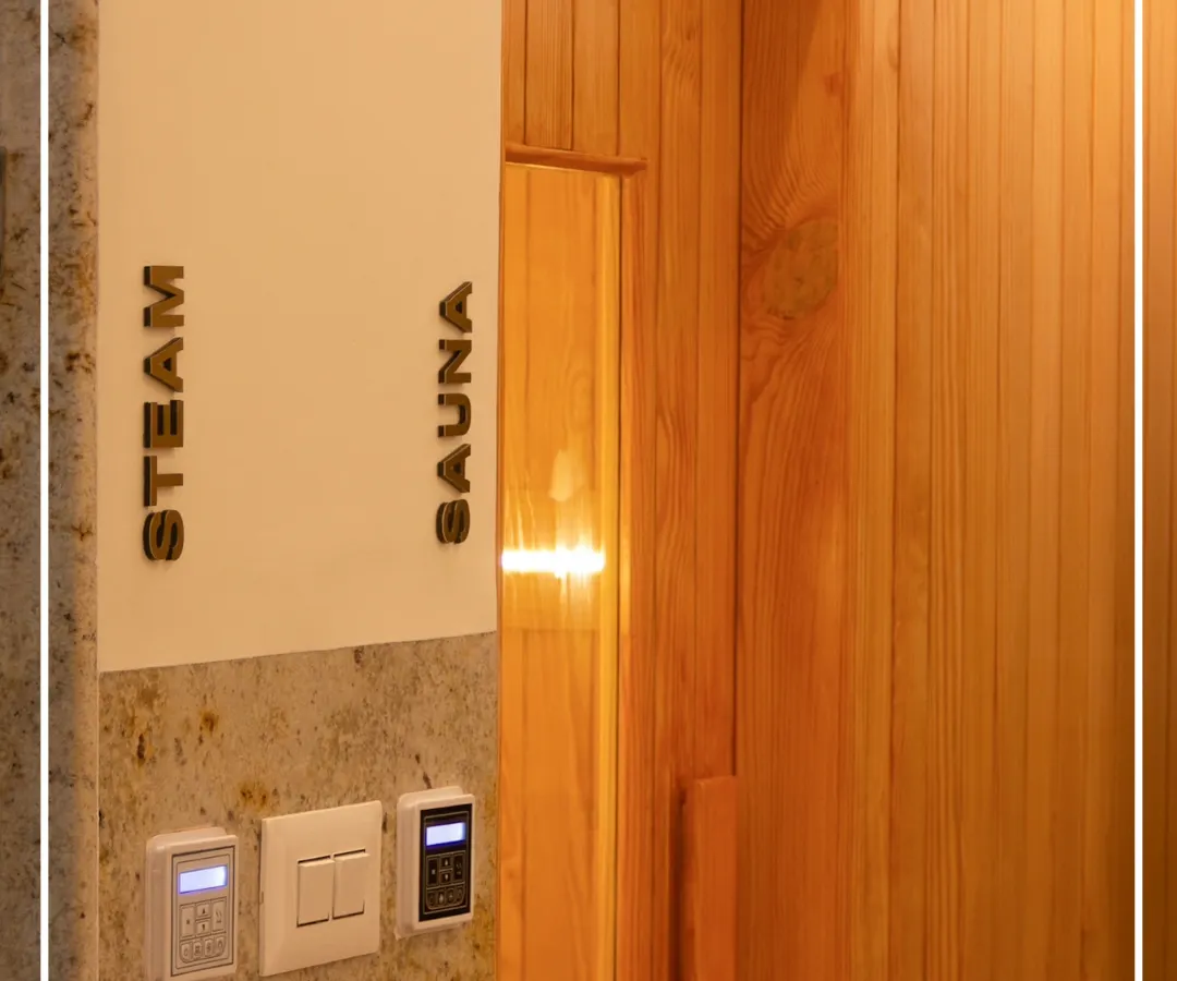 Modern wellness amenities, like these new steam and sauna rooms, are seamlessly integrated into the heritage setting of the Bangalore Club. The design uses warm wood paneling and clear signage to create a functional, spa-like experience that respects the original structure.