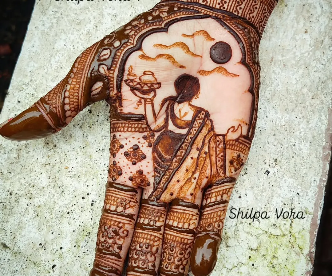 A classic Karwa Chauth design, featuring the traditional scene of a woman with a puja thali looking at the moon. I can incorporate names and other personal elements to make your festive mehndi unique.