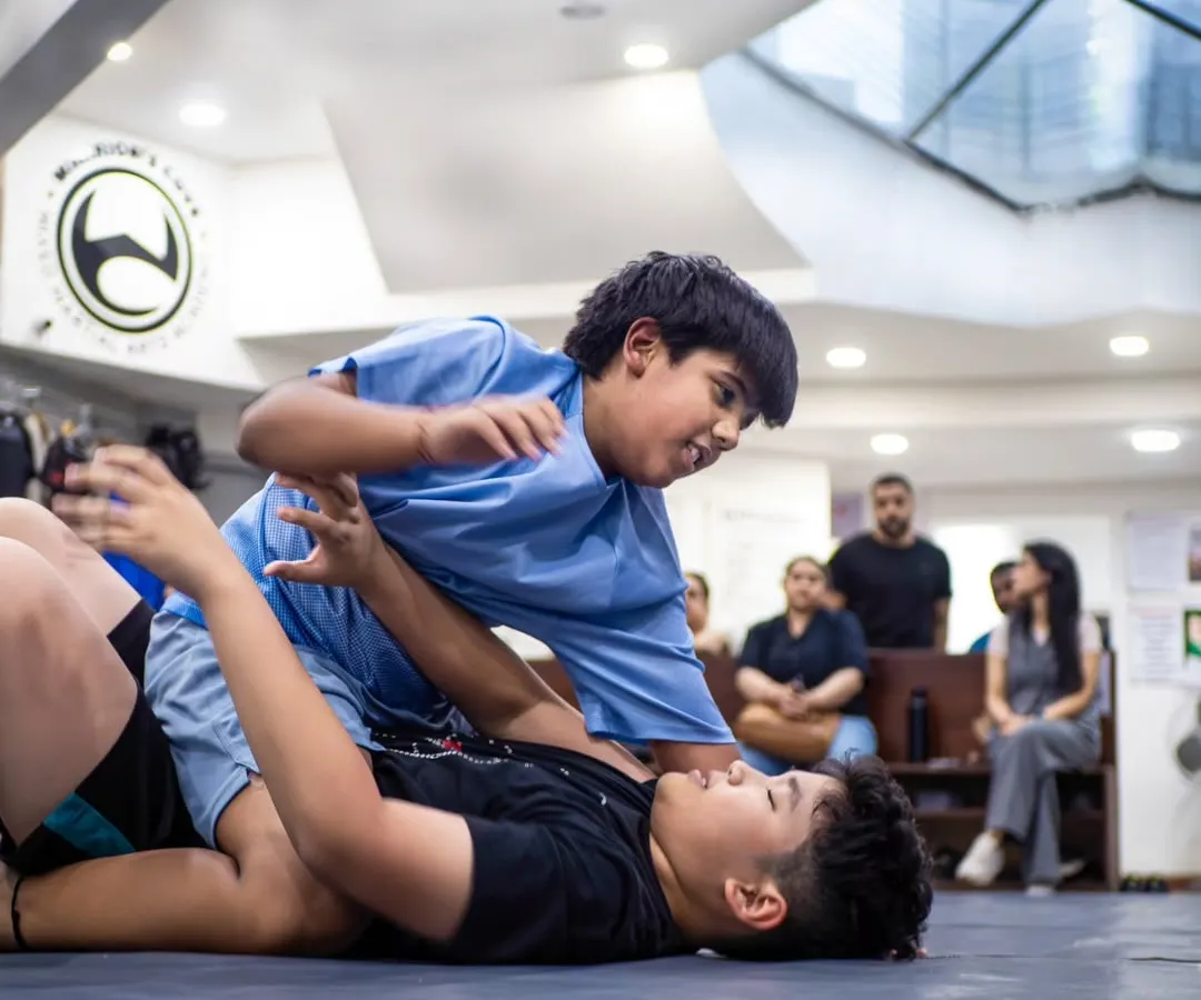 This is Brazilian Jiu-Jitsu in action. Here, two of our young warriors learn to use technique and leverage, not just size, to control a situation. It's a physical chess match that builds critical thinking under pressure.