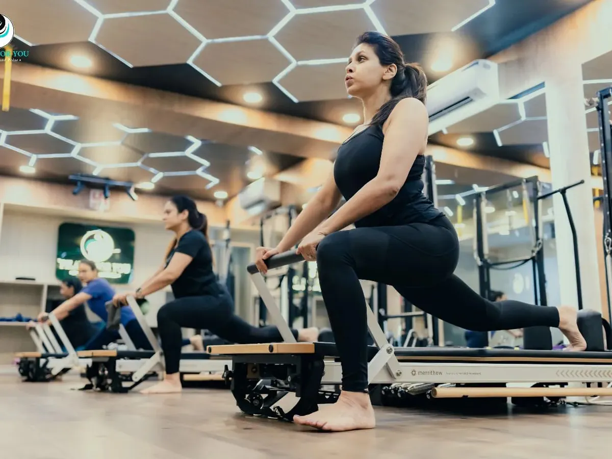 A group of clients performing a synchronized lunge on the reformer. This exercise is excellent for building lower body strength, improving balance, and engaging the core, all key components of my group classes at the Hauz Khas studio.
