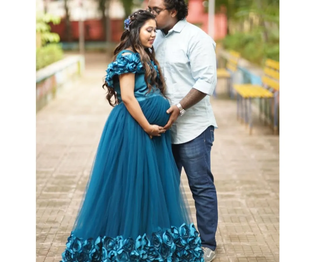Planning a couple's maternity shoot is a wonderful way to capture this time together. Here, my client wears the teal floral gown while her partner stays comfortable and casual. I can help you style a coordinated look that feels authentic to you both.