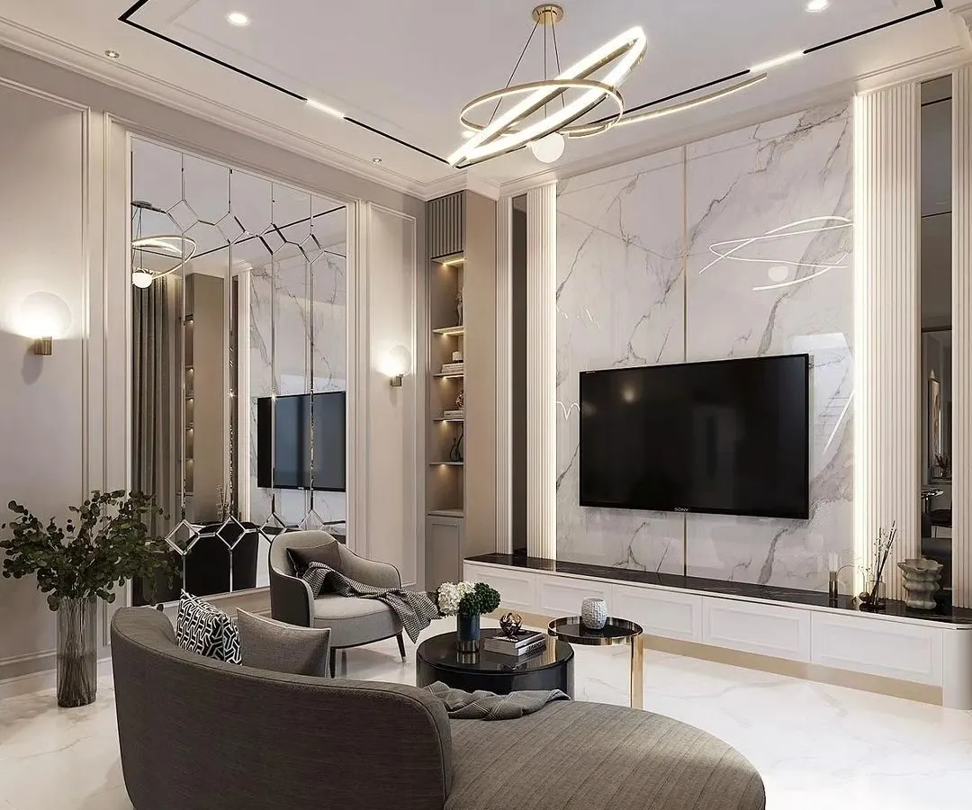 I designed this living room to be a statement of modern luxury. The centerpiece is a full-wall media unit with a marble-finish backdrop and integrated accent lighting. The space is tied together with a contemporary chandelier, custom wall paneling, and a curved sofa that enhances the room's sophisticated flow.