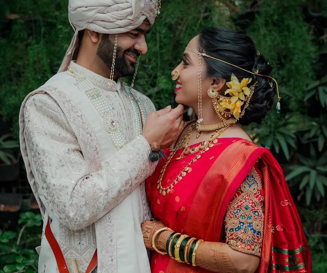 A quiet moment between the wedding rituals. I believe the most beautiful portraits are the ones that are not posed but felt, like this gentle touch that says more than words ever could. This is a classic Maharashtrian wedding couple portrait.