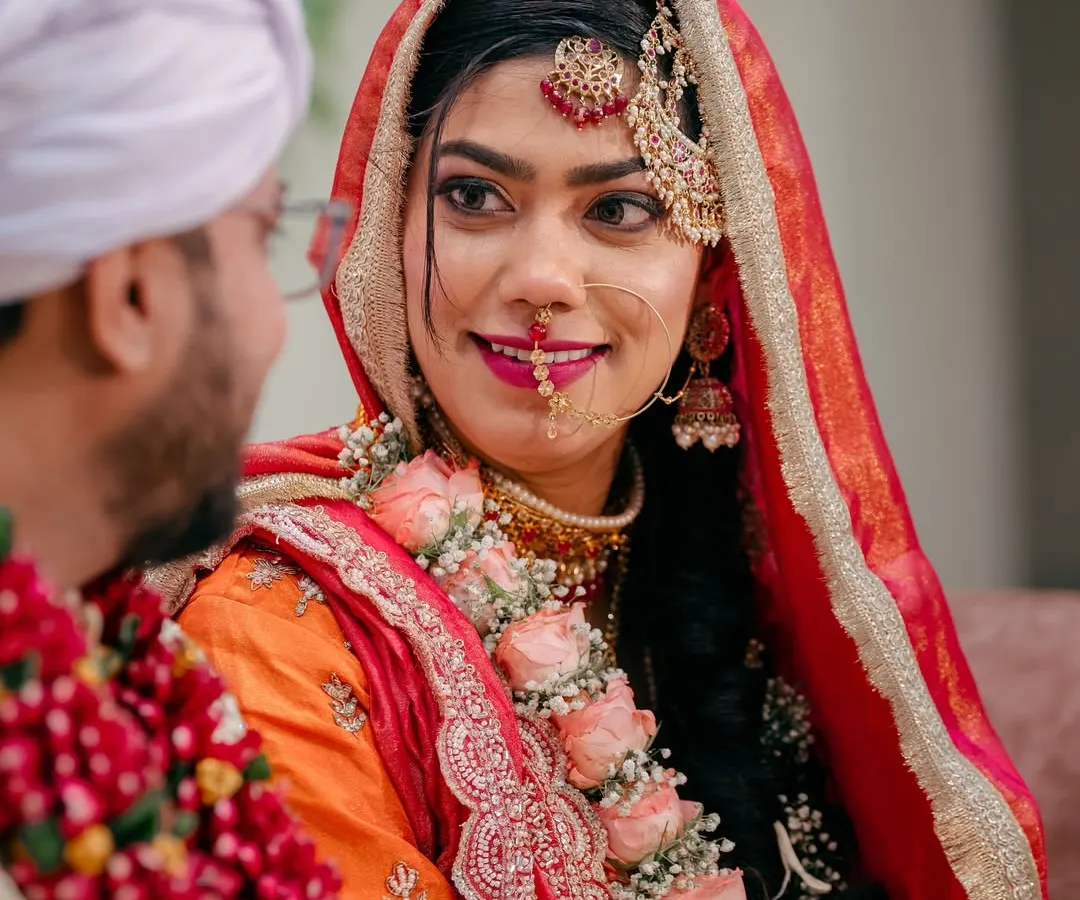A candid glance between the bride and groom during their Nikah ceremony. I focus on capturing these unscripted, heartfelt interactions that tell the true story of your day.