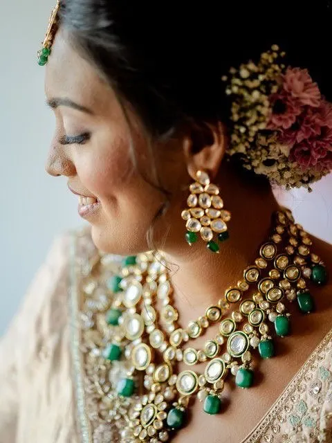 A bridal look is all in the details. Here, I focused on creating a flawless, dewy base to let her natural beauty shine, complemented by soft eye makeup and a floral bun. This close-up captures the timeless elegance perfect for a wedding day.