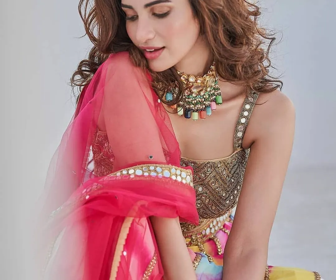 For a vibrant sangeet or mehendi, a pop of color can be stunning. Here, I created a soft glam look with a flawless base that complements the bride's colorful lehenga. The makeup is designed to be bright and joyful while still looking polished and elegant.