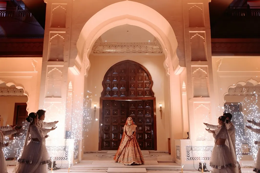 A bride's entry should be nothing short of majestic. We conceptualized this royal procession with a stunning architectural backdrop and perfectly timed cold pyros to create a truly regal and unforgettable varmala moment.