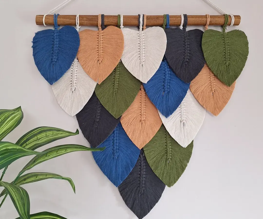 We love bringing the textures and colors of nature into your home. This macrame leaf wall hanging is handcrafted with natural cotton and can be customized with your favorite color palette to create the perfect earthy, cozy vibe for your living room or bedroom.
