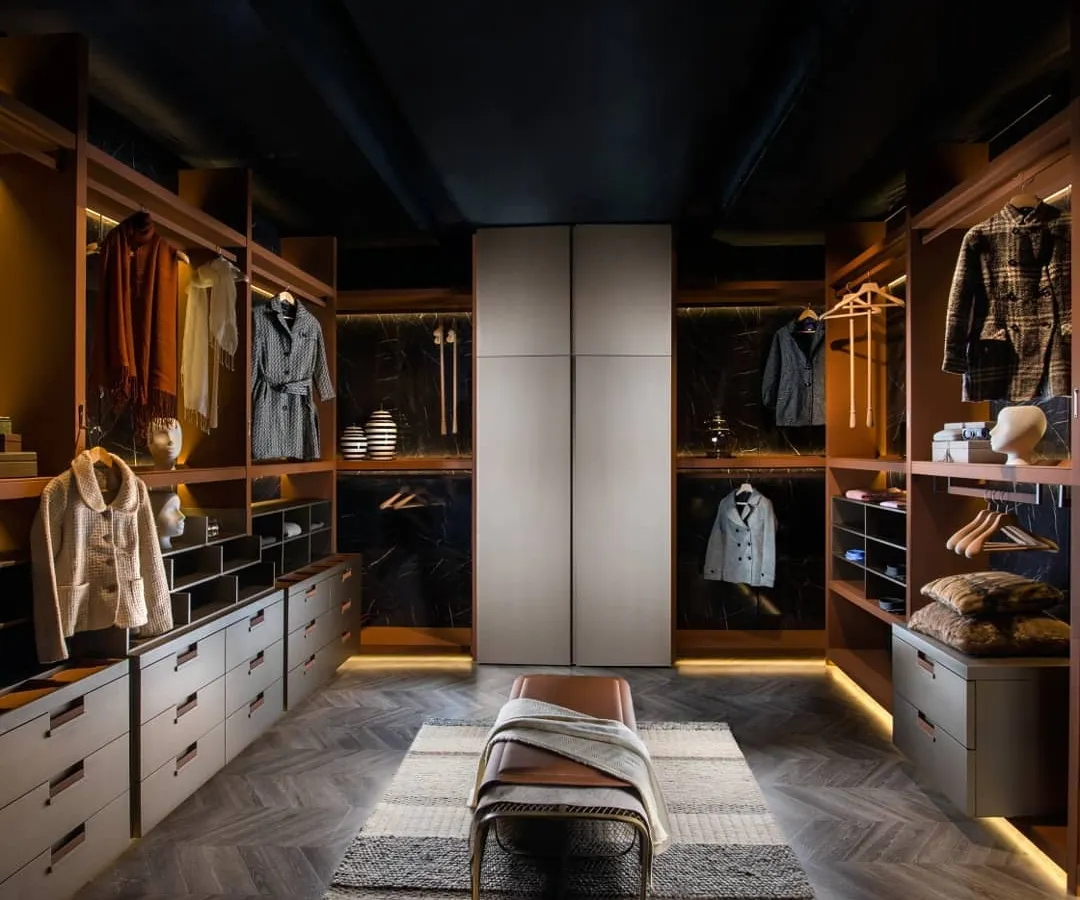 We believe a wardrobe should be a luxurious dressing space. This walk-in closet is designed with clean lines and warm, ambient lighting, featuring a mix of open shelving and drawer units to create a perfect, organized solution for your entire collection.