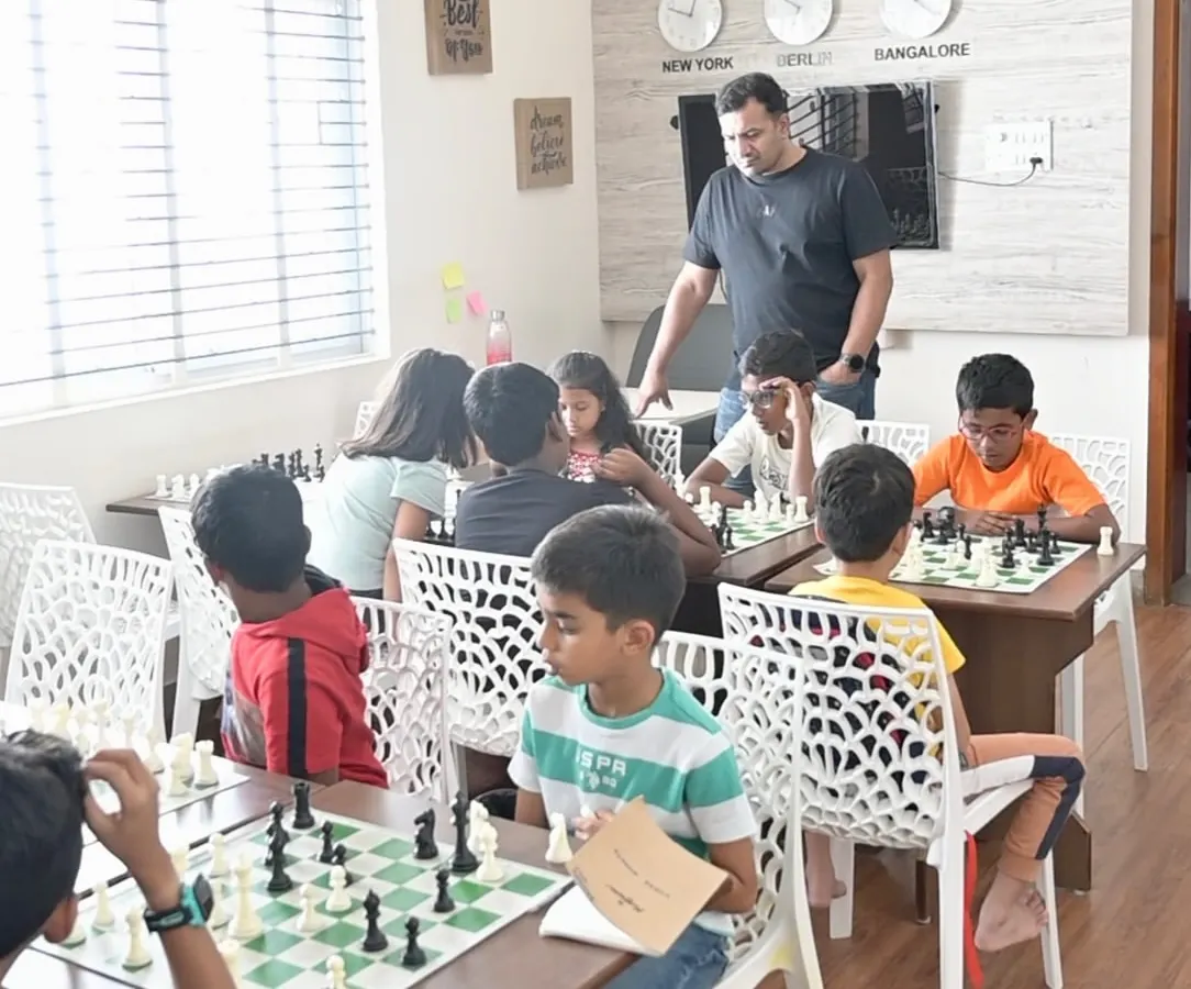 We keep our batches small to ensure every child gets personal attention. Here, one of our FIDE-rated coaches observes a session, ready to provide guidance and help students think through their moves.