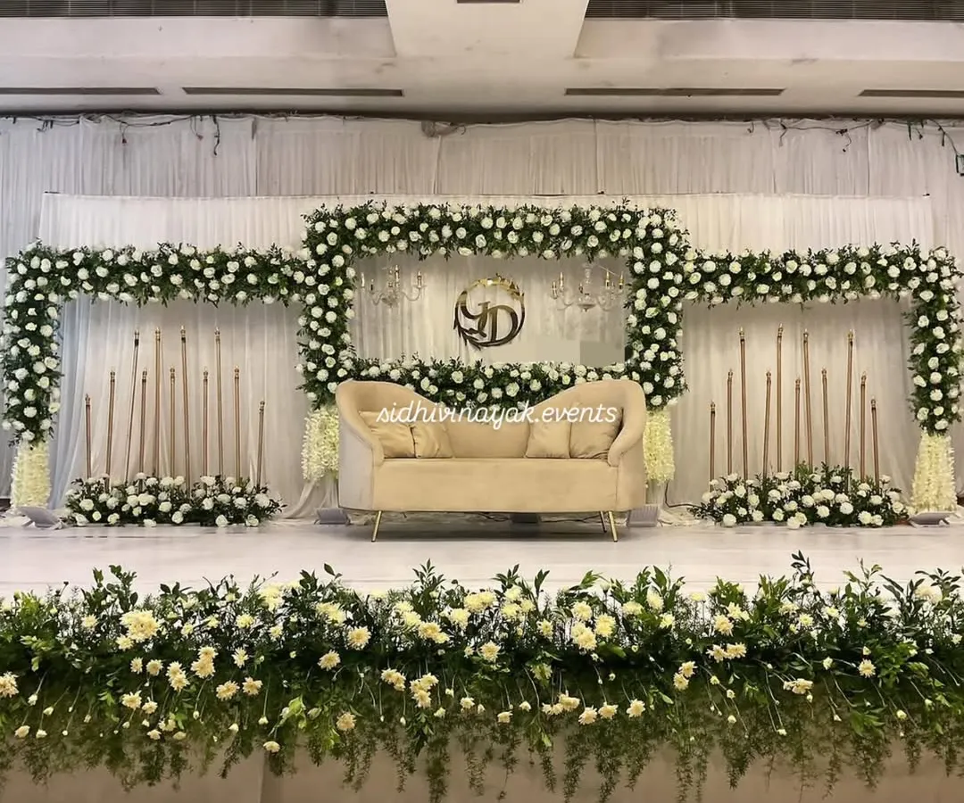 For a classic and elegant look, I design stunning engagement stages like this one. The lush white floral arrangement, combined with soft lighting and a beautiful monogram, creates a sophisticated backdrop for your celebration.