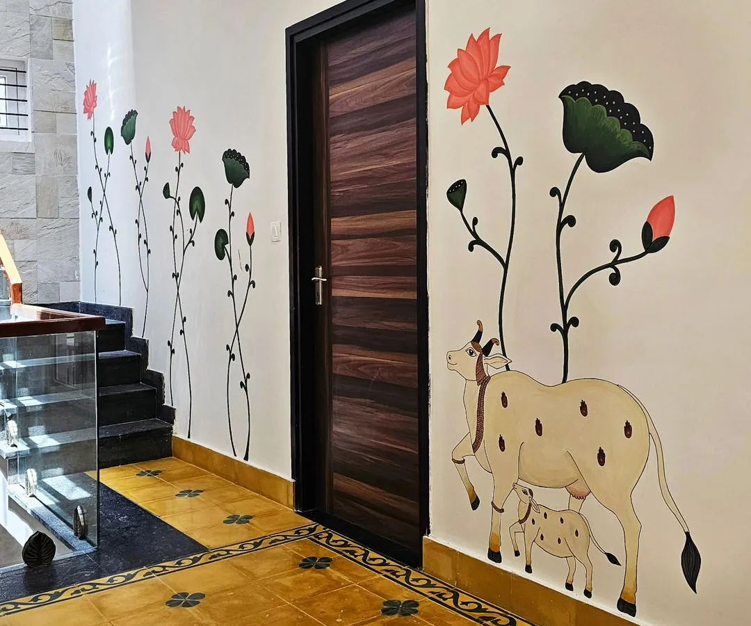 I love the clean, elegant look of Pichwai art. For this study area, I painted a serene cow and calf motif alongside delicate lotus stems, creating a peaceful atmosphere that complements the Indian-themed flooring.
