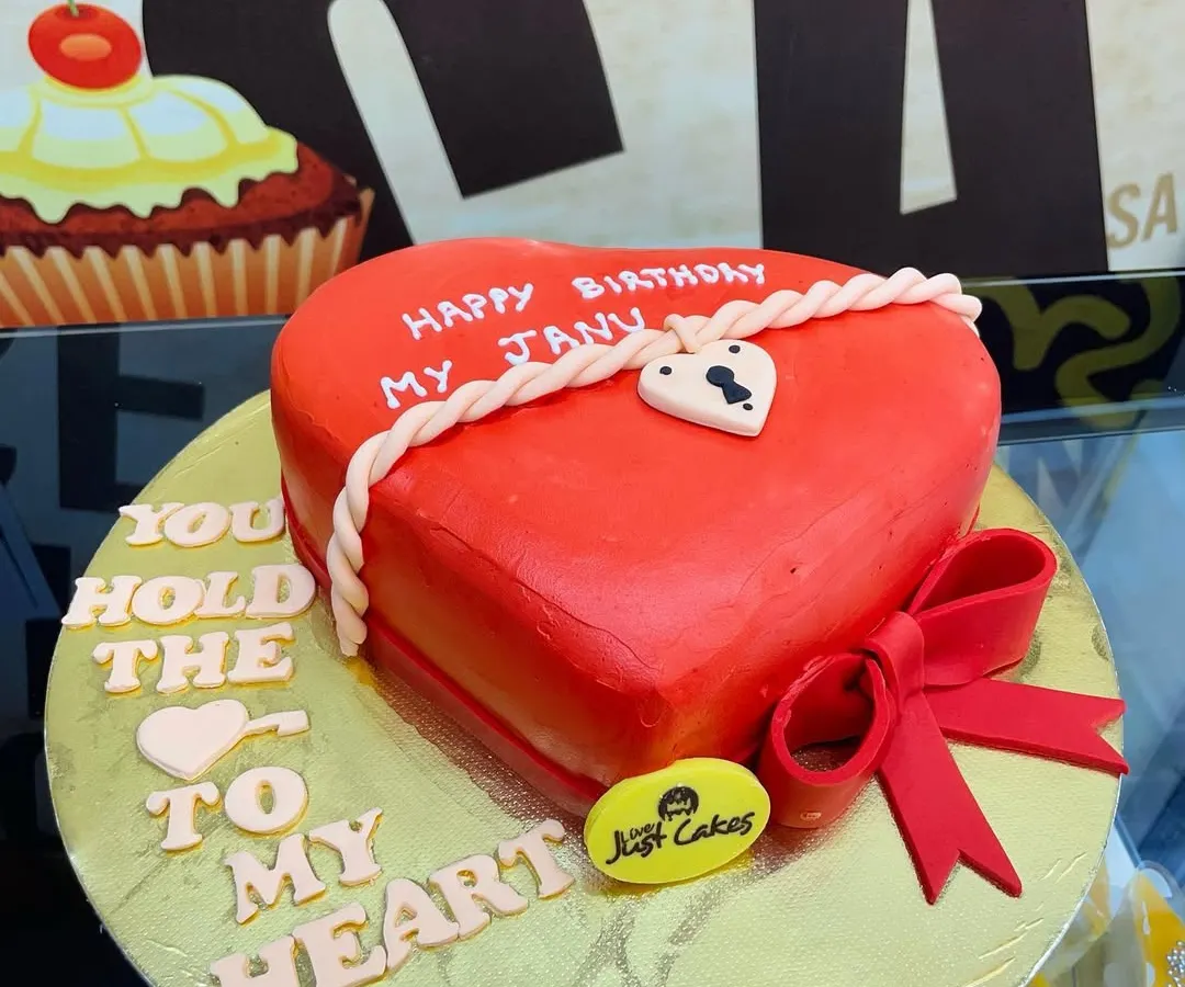 A vibrant red, heart-shaped fondant cake perfect for expressing love on a birthday, anniversary, or Valentine's Day. The intricate rope and lock details add a personalized touch.