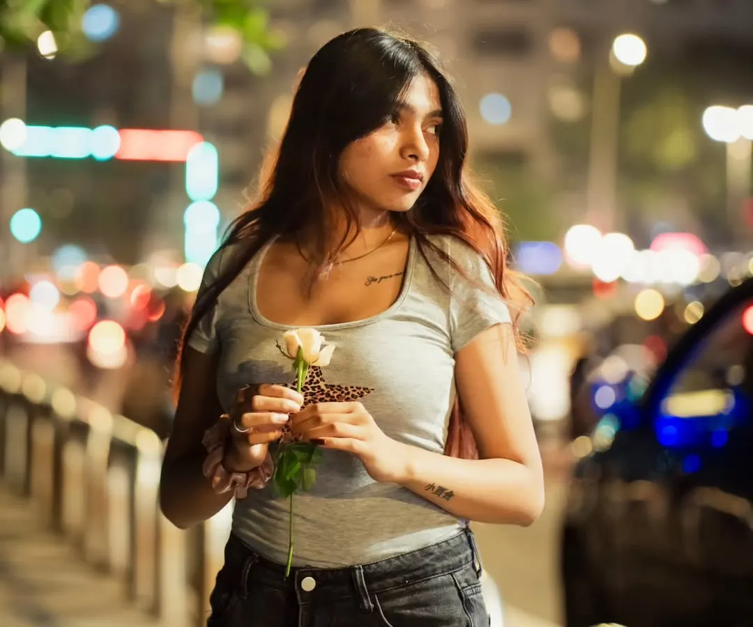 A moody night portrait captured on the streets of Mumbai. I use the city's ambient light to create a filmic vibe, focusing on emotion and atmosphere for influencer-style content.