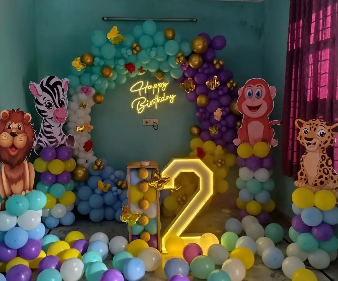 I can bring any theme to life, like this vibrant jungle-themed party for a second birthday. The setup includes a full balloon ring, large cutouts of jungle animals like a lion, zebra, and monkey, and a light-up marquee number.