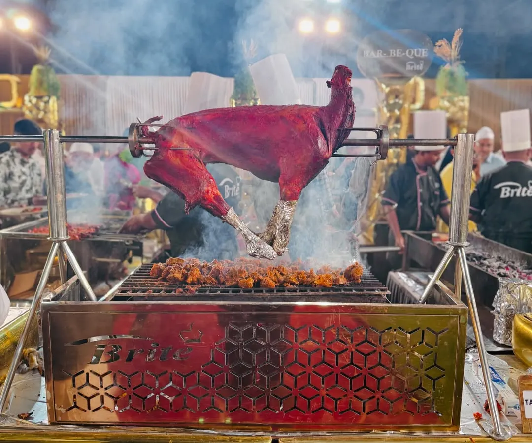 The centerpiece of our live barbecue station, a whole tandoori-spiced goat slow-roasting over charcoal. The sight and smoky aroma create an interactive and theatrical dining experience that guests talk about long after the event.